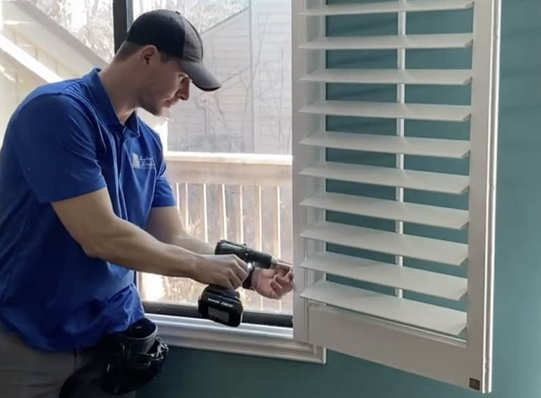 SoCal Window Coverings employee installing shutters in home